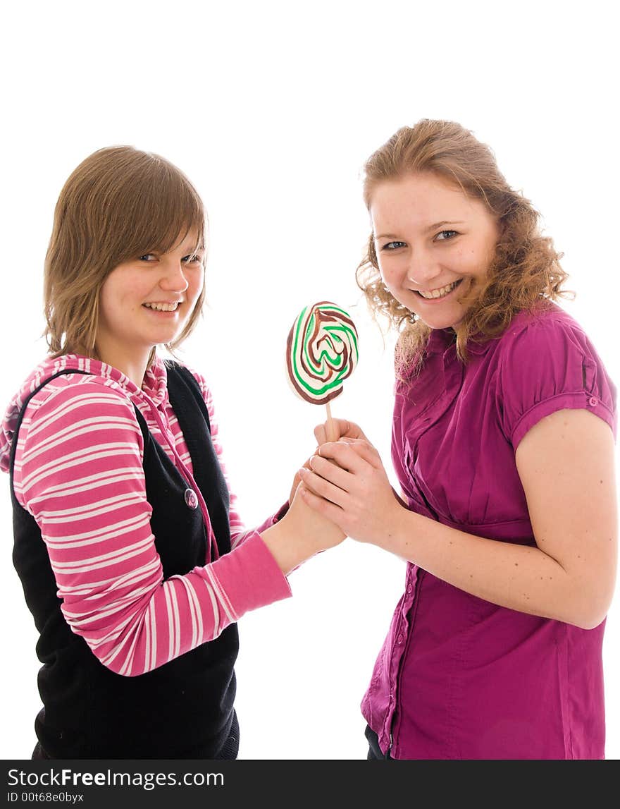 The two girls with a sugar candy isolated on a white background