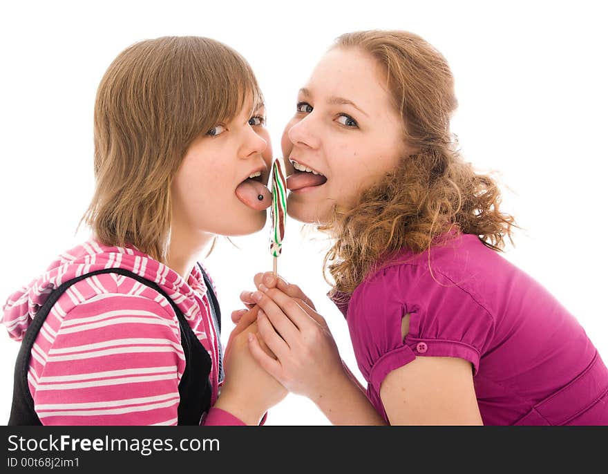 The two girls with a sugar candy isolated on a white background