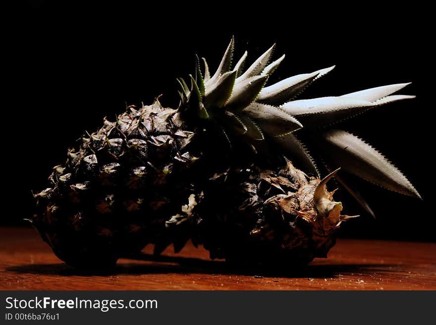 2 pineapples isolated in wood background