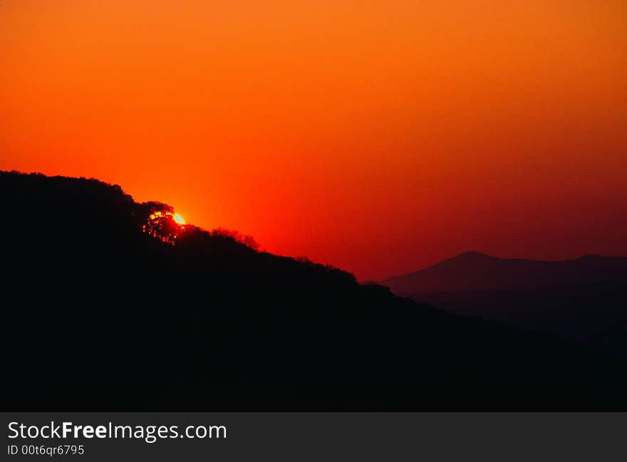 Smoke from forest fires colored red by setting sun as it set behind Magazine Mountain. Smoke from forest fires colored red by setting sun as it set behind Magazine Mountain