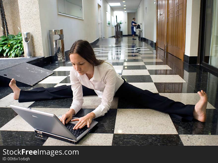 Woman on the floor working on her laptop. Woman on the floor working on her laptop