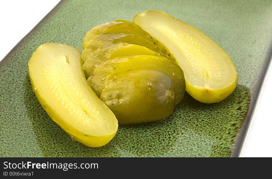 Sliced full sour pickles on a plate. Sliced full sour pickles on a plate.