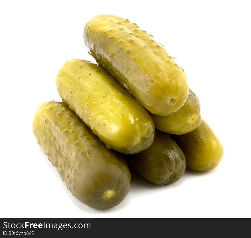 Pyramid of full sour pickles isolated on white background.