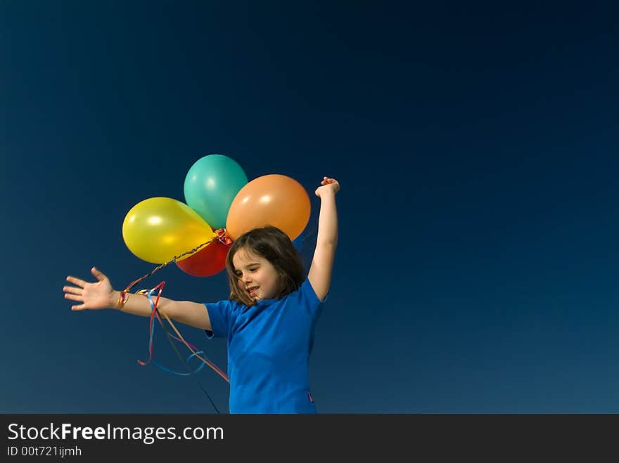 Girl holding balloons against blue sky. Girl holding balloons against blue sky