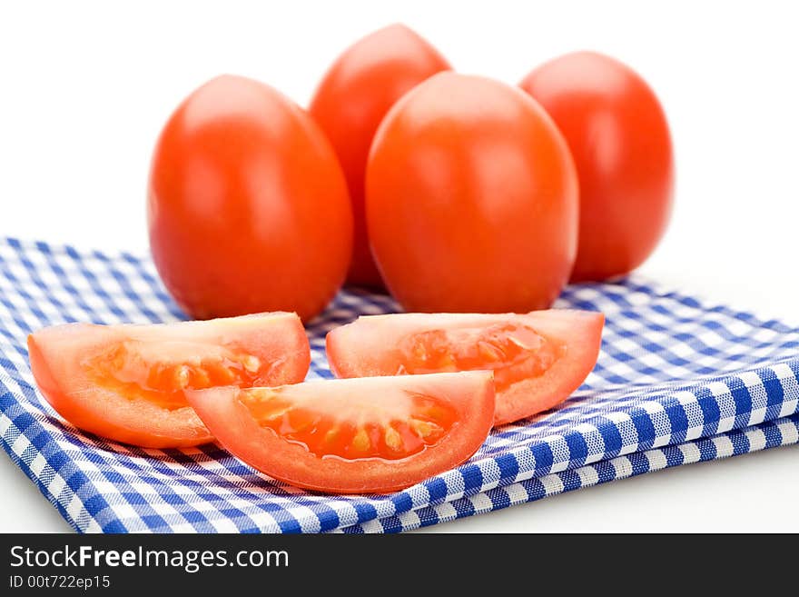 Red tomatoes on a blue cloth