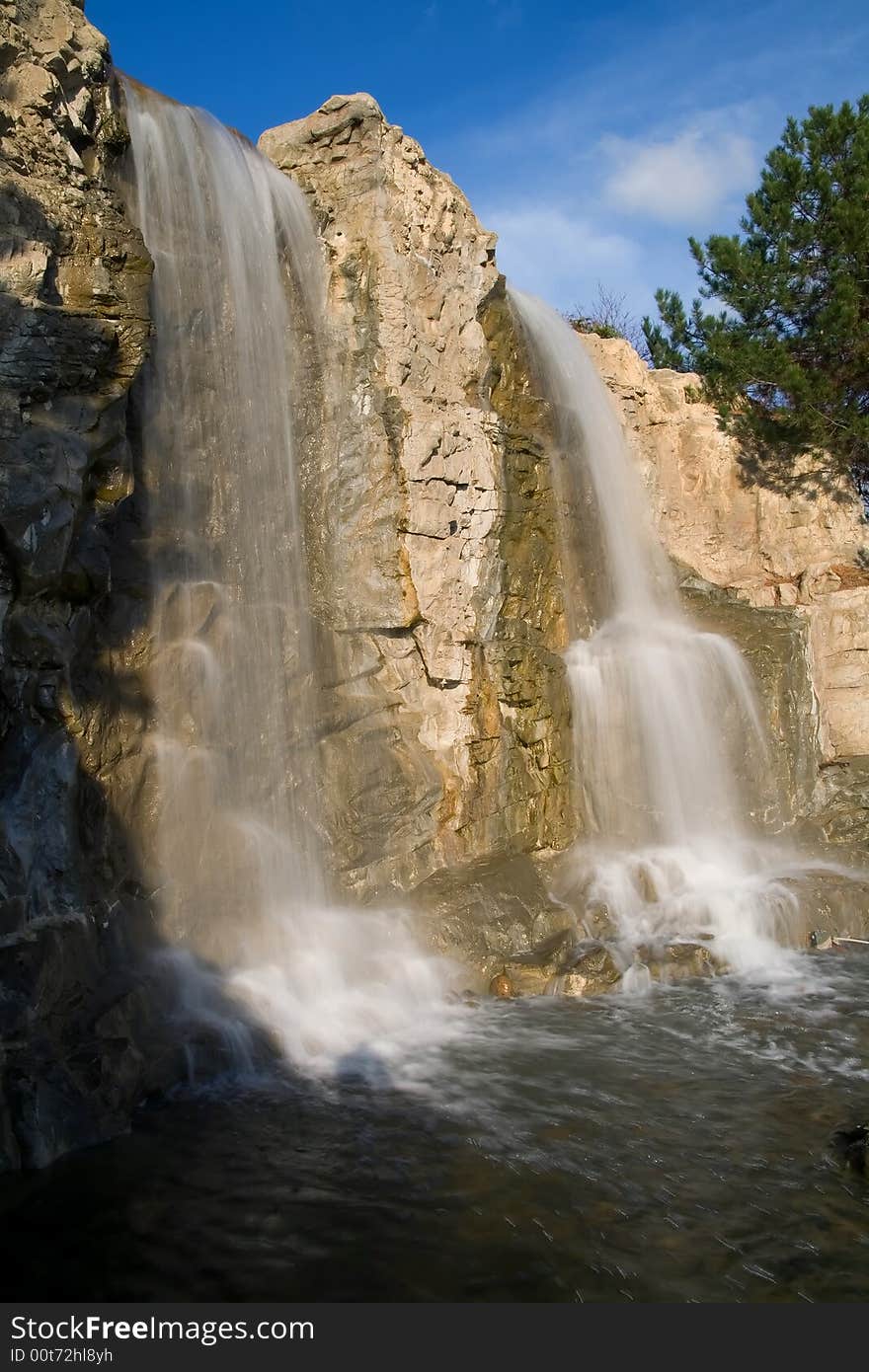 Two waterfalls with cloudy sky