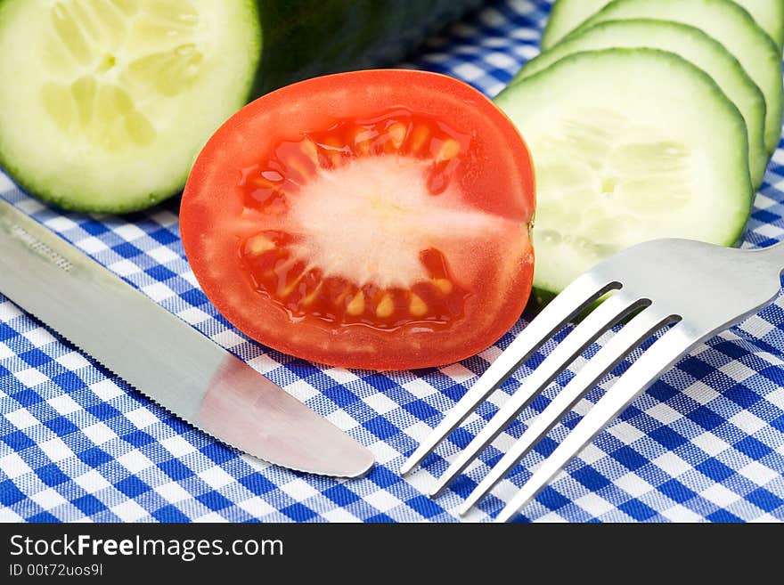 Tomato And Cucumber On Checked Background