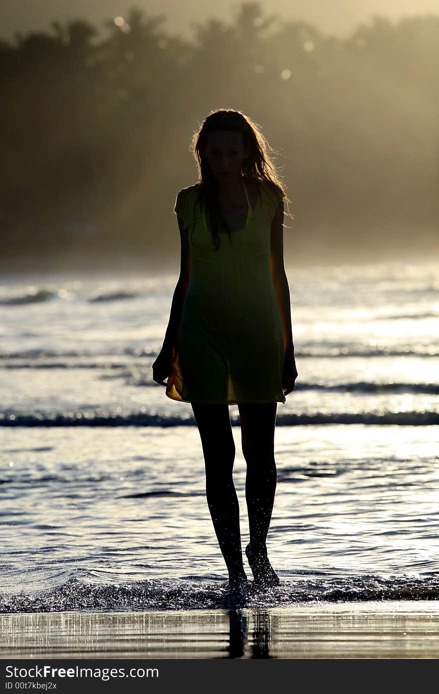 Woman silhouette by sunset in the caribbean