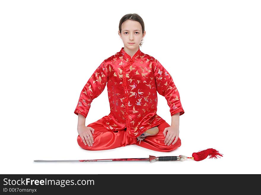 Wushu girl with sword sits on white