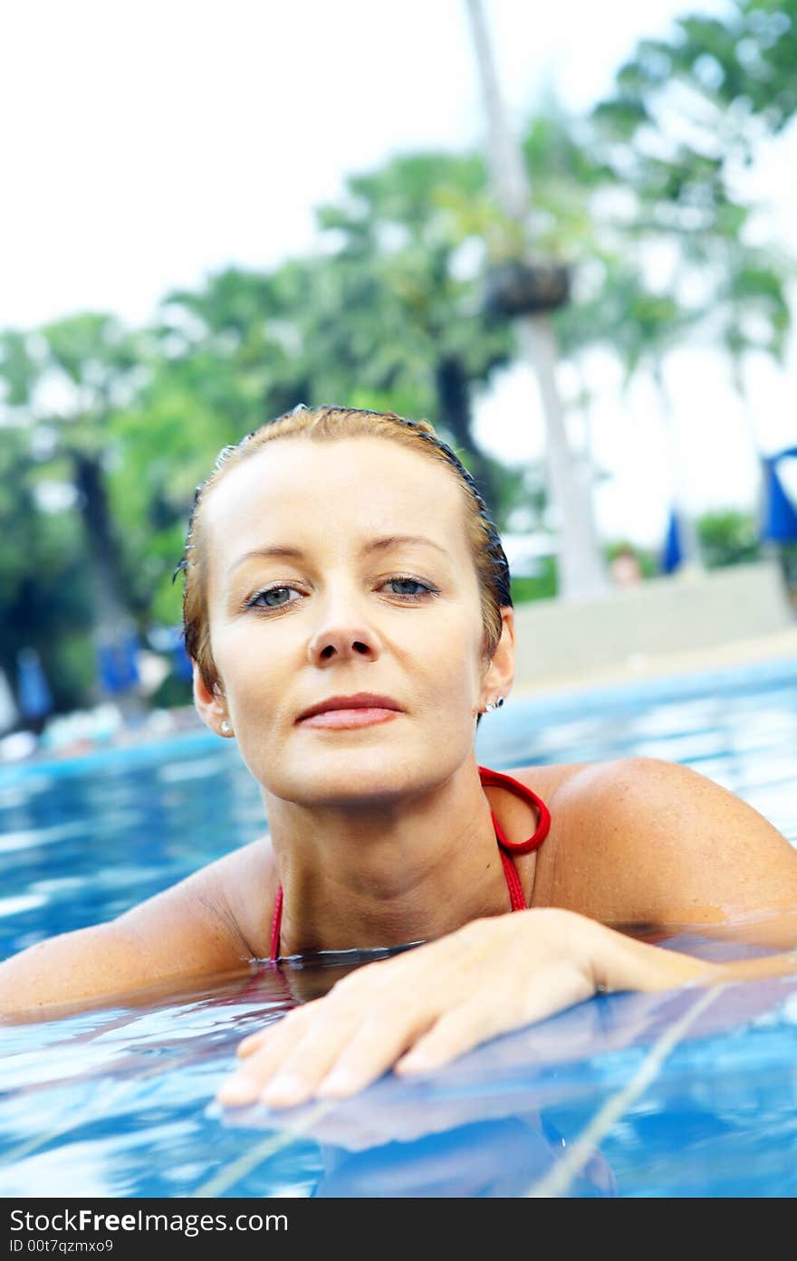 Portrait of nice young woman relaxing in swimming pool. Portrait of nice young woman relaxing in swimming pool