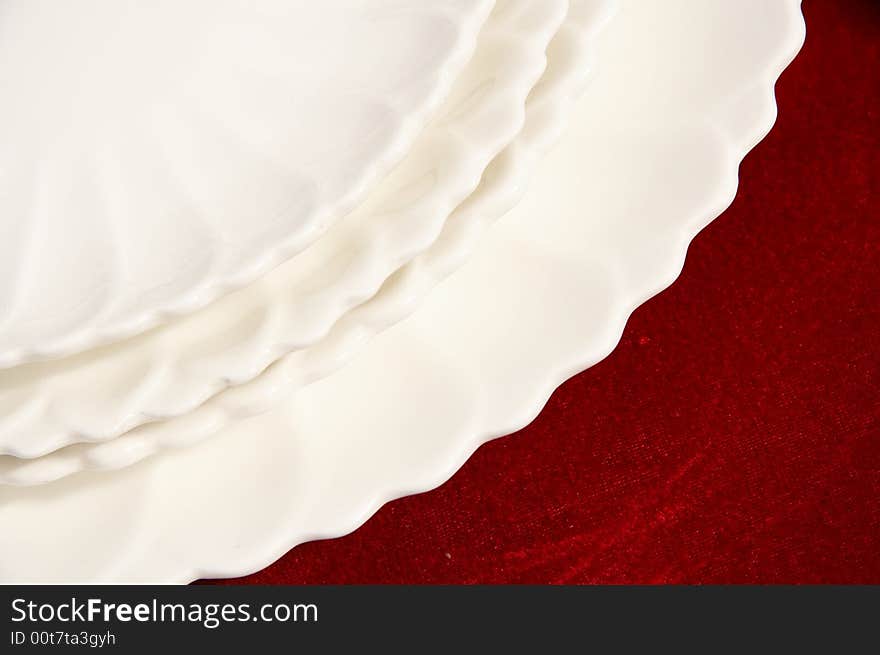 White plates isolated on red