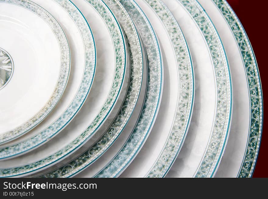 A pile of plates,same style,different size,displaying on sale. A pile of plates,same style,different size,displaying on sale