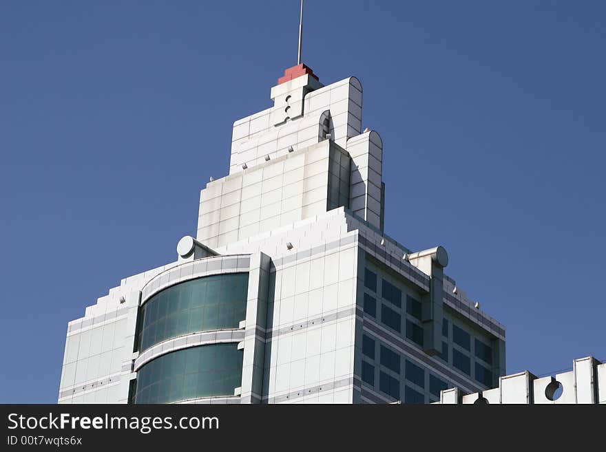 Green office building under clear blue sky