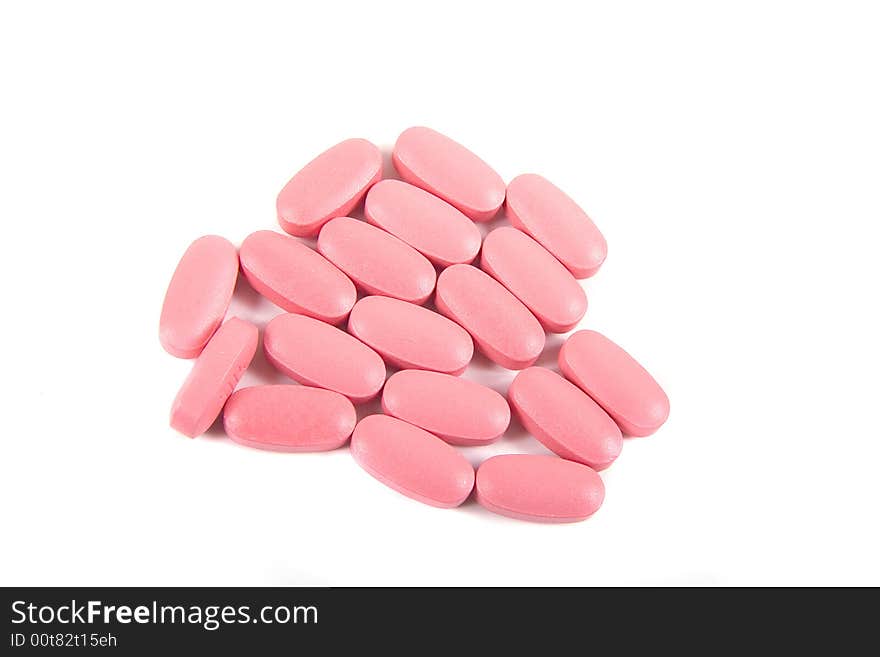 Pink tablets or medicine on a white background