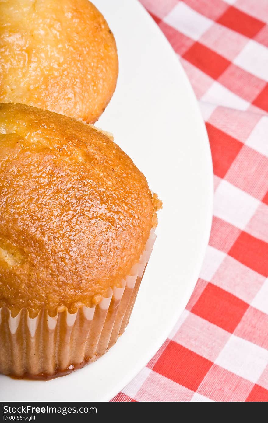 Fresh hot homecooked cornbread muffins close up on a white plate