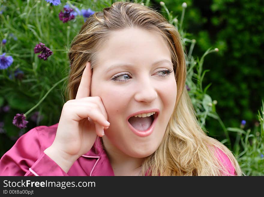 Attractive enthusiastic  female with an idea.
She has her mouth open,forefinger on her forehead with a determined  expression on her face. Captured in the garden. Attractive enthusiastic  female with an idea.
She has her mouth open,forefinger on her forehead with a determined  expression on her face. Captured in the garden.