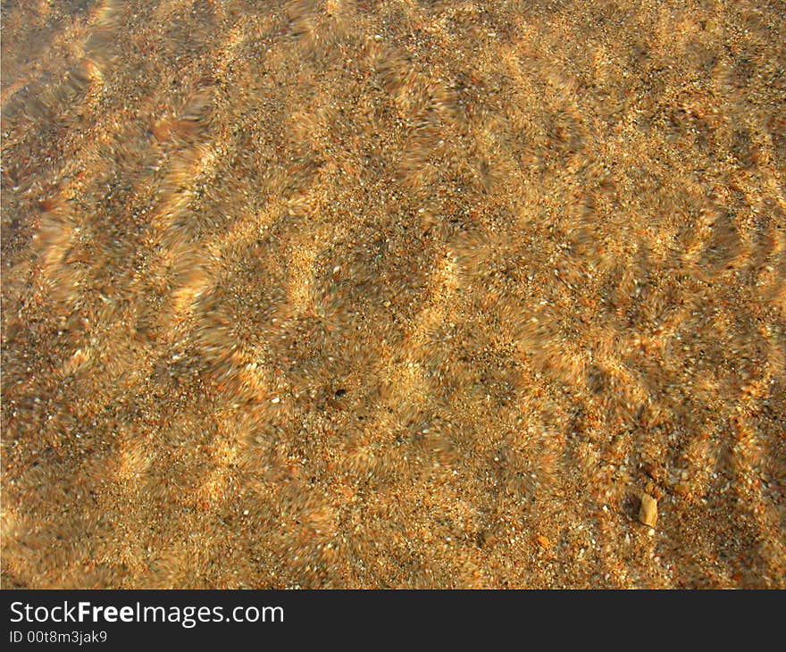 Sand under clear water glittering on sun. Sand under clear water glittering on sun