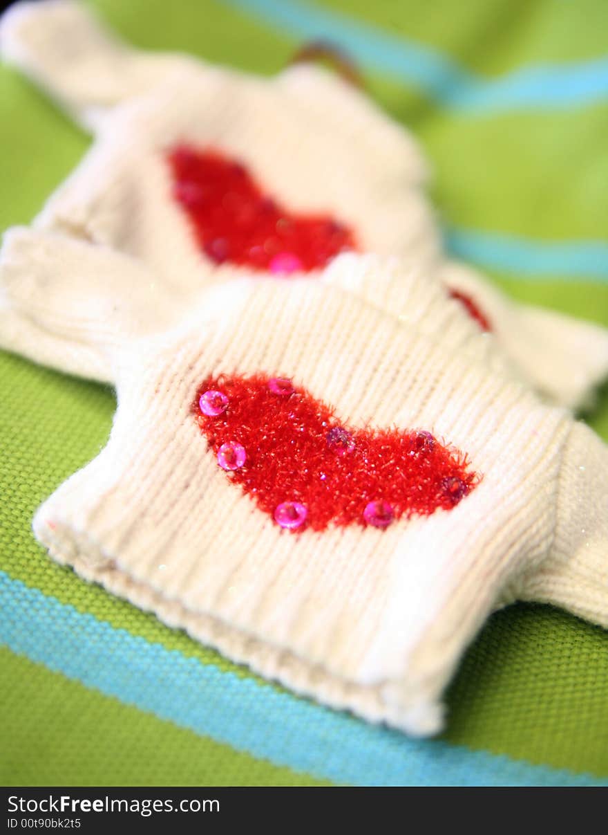 Tiny knitted sweater with hearts and sequins