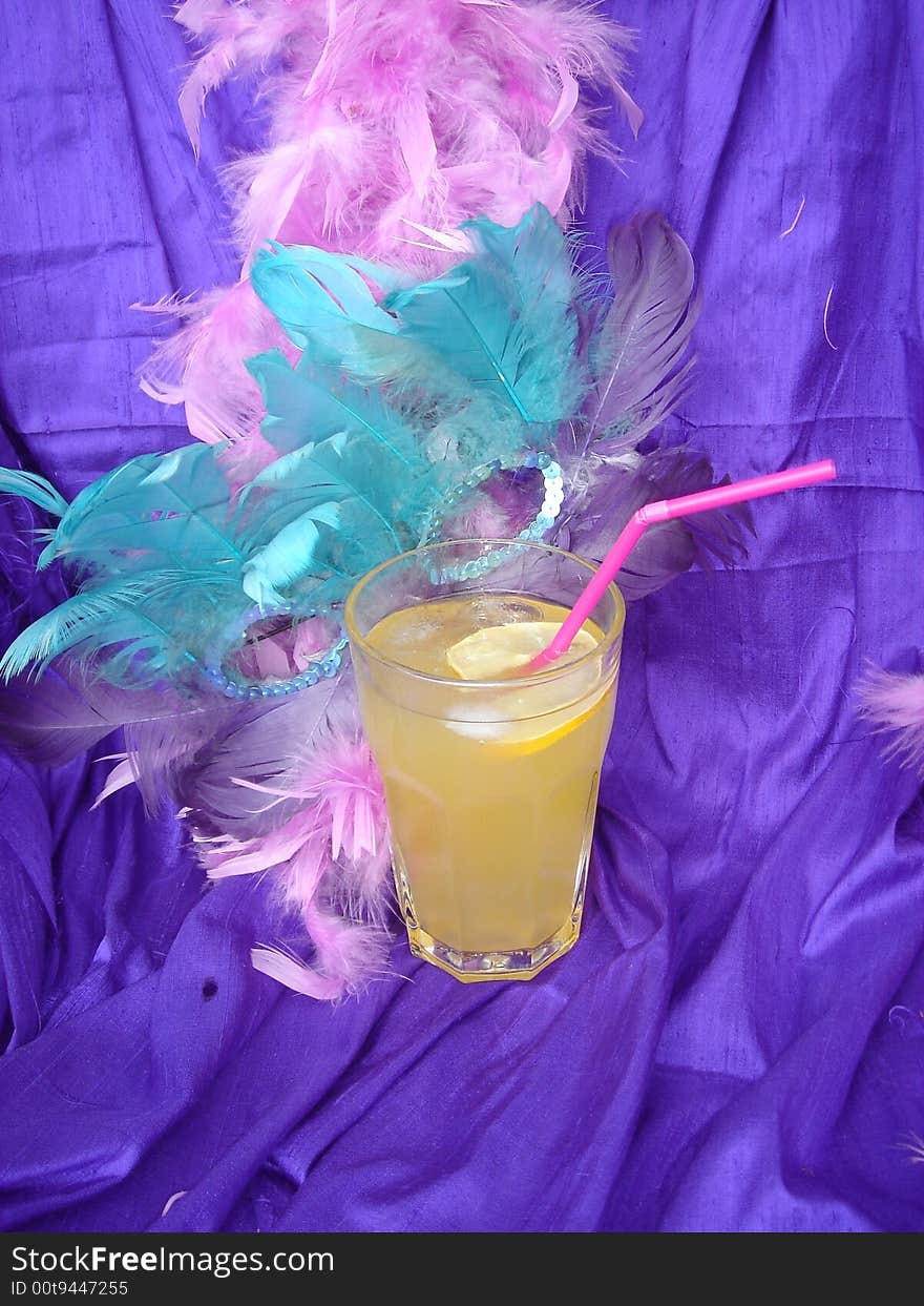 Yellow carnival drink on the purple back ground. Yellow carnival drink on the purple back ground