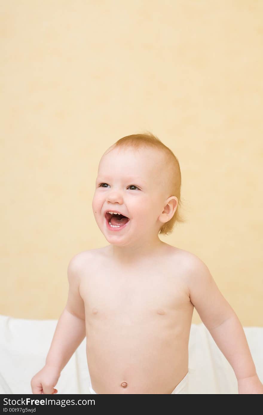 Enjoying baby stand on bed