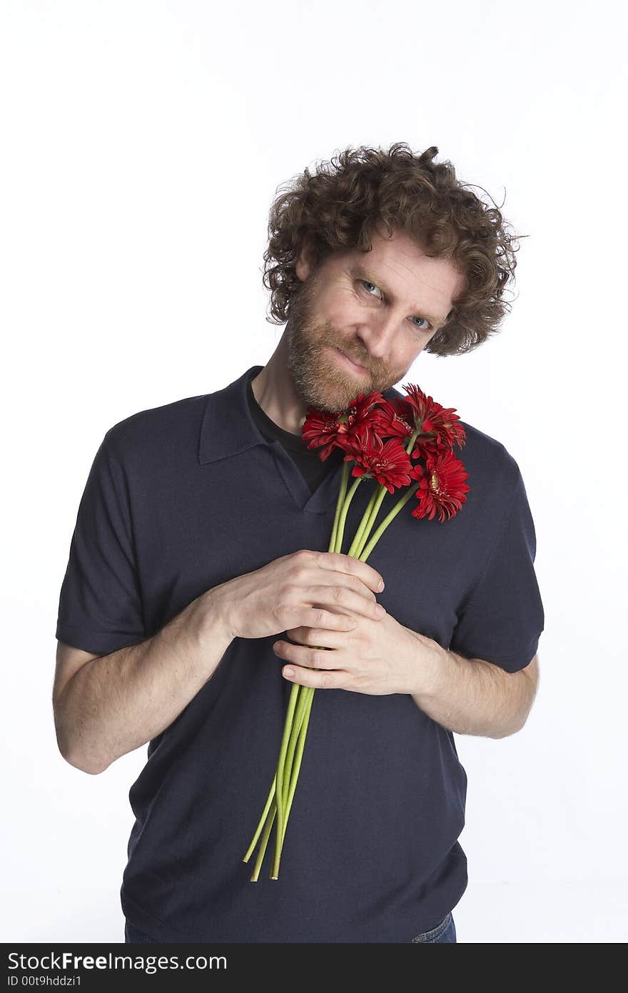 Man holding a bunch of flowers and looking apologetic. Man holding a bunch of flowers and looking apologetic