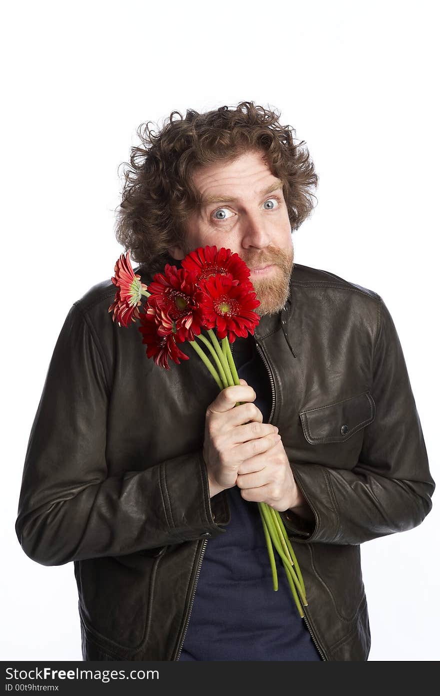 Man holding a bunch of flowers and looking apologetic. Man holding a bunch of flowers and looking apologetic