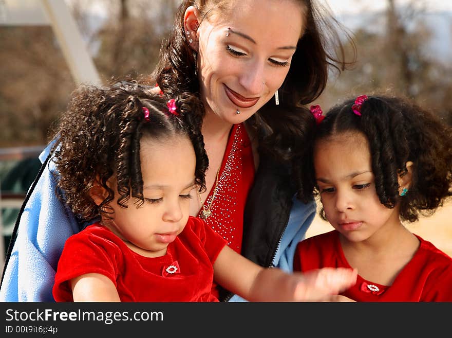 Beautiful multiracial children with afro hairstyle reading a book. Beautiful multiracial children with afro hairstyle reading a book