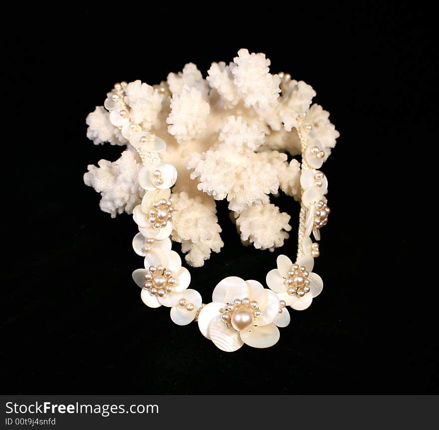 Mother-of-pearl vintage necklace on the white coral branch. Mother-of-pearl vintage necklace on the white coral branch