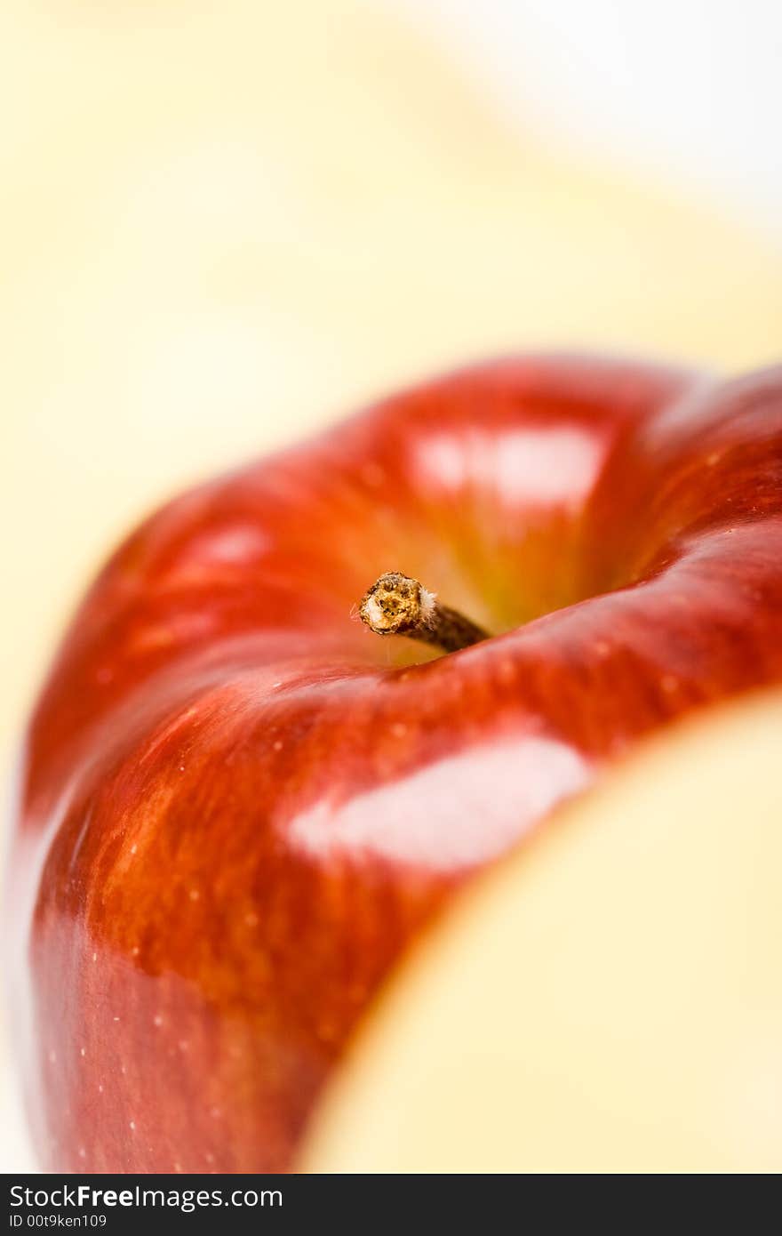 One closeup red apple with yellow backgounds. One closeup red apple with yellow backgounds