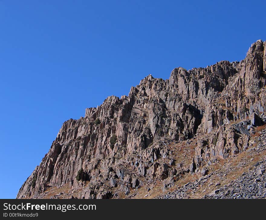 Grey rocks on blue sky background