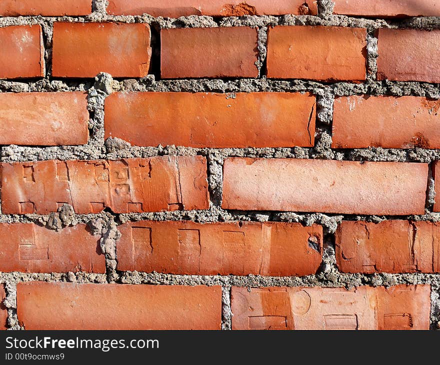 Old brick wall with bright orange bricks