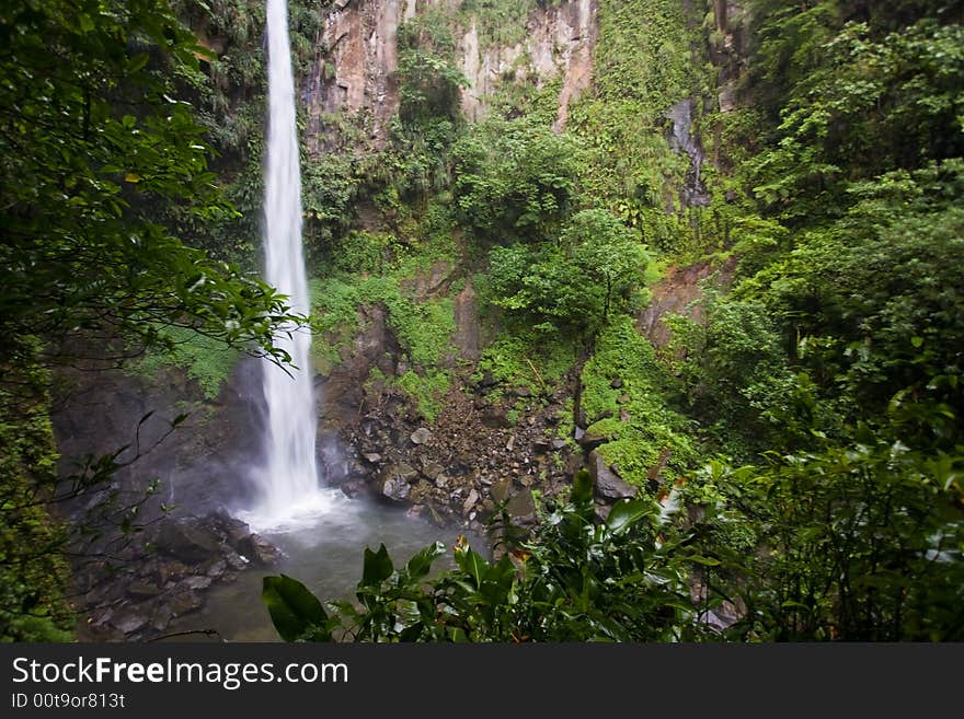 Spectacular waterfall and pool on lush tropical island. Spectacular waterfall and pool on lush tropical island