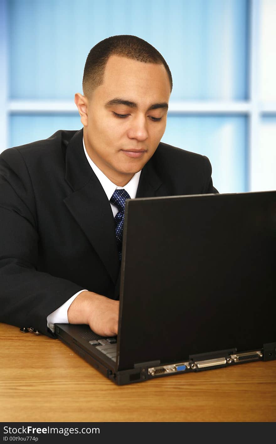 Business man working with his laptop in contemporary business environment. Business man working with his laptop in contemporary business environment