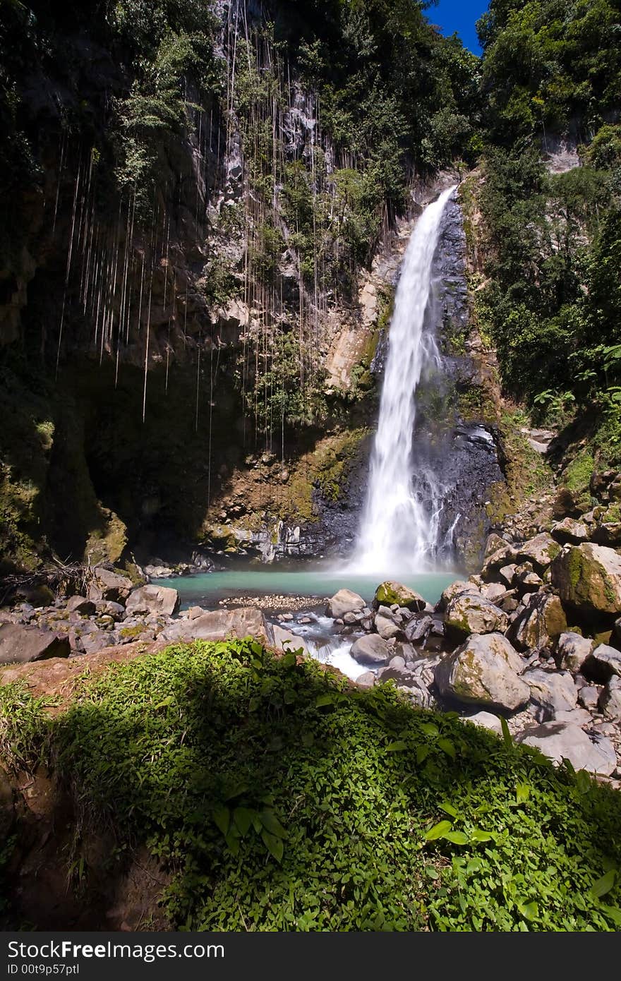 Spectacular waterfall and pool on lush tropical island. Spectacular waterfall and pool on lush tropical island