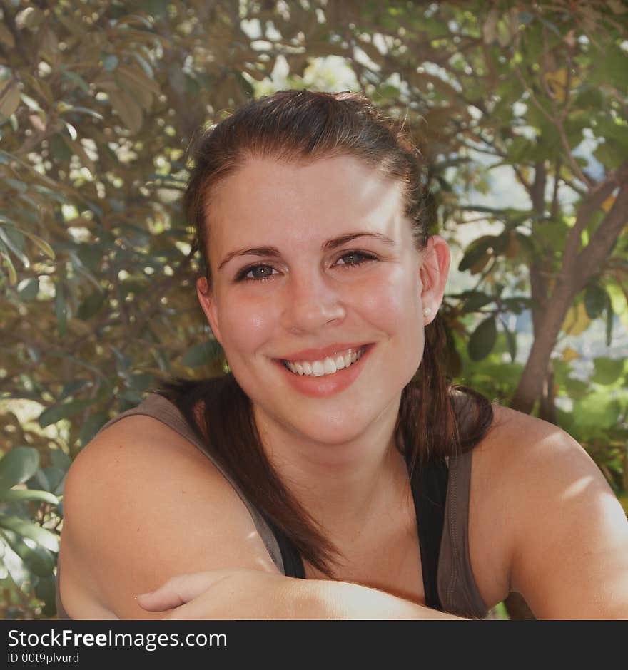 Young Healthy energetic looking girl with bluch on cheeks dressed in sportswear happy and smiling. Young Healthy energetic looking girl with bluch on cheeks dressed in sportswear happy and smiling