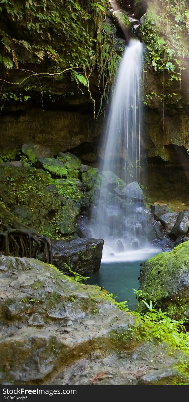 Spectacular waterfall and pool on lush tropical island. Spectacular waterfall and pool on lush tropical island