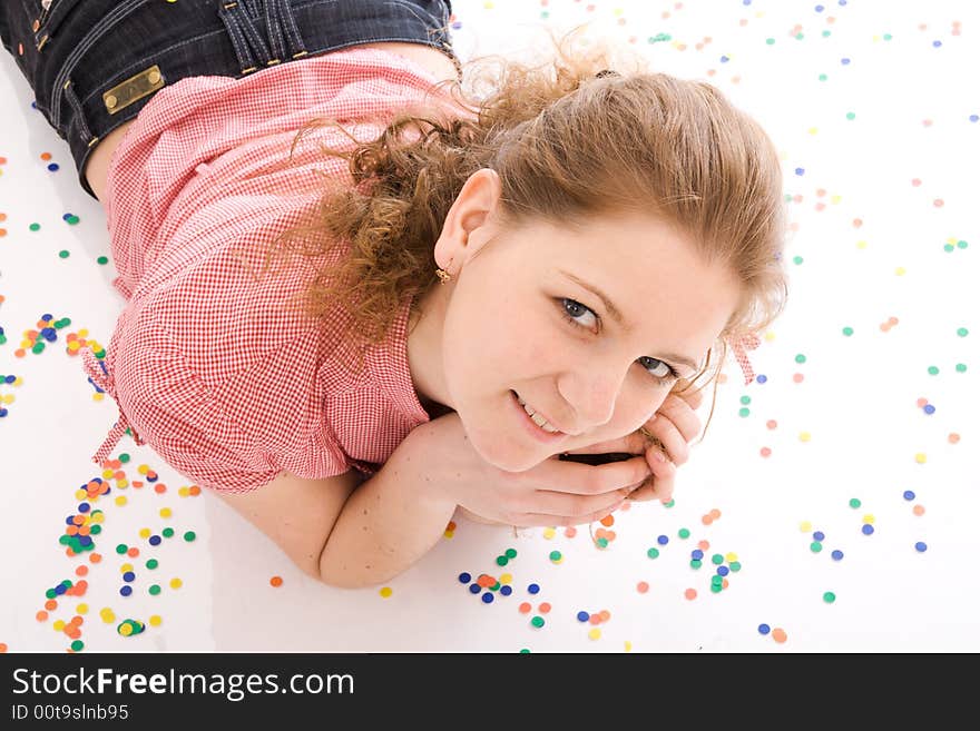 The young beautiful girl with the confetti isolated on a white background. The young beautiful girl with the confetti isolated on a white background