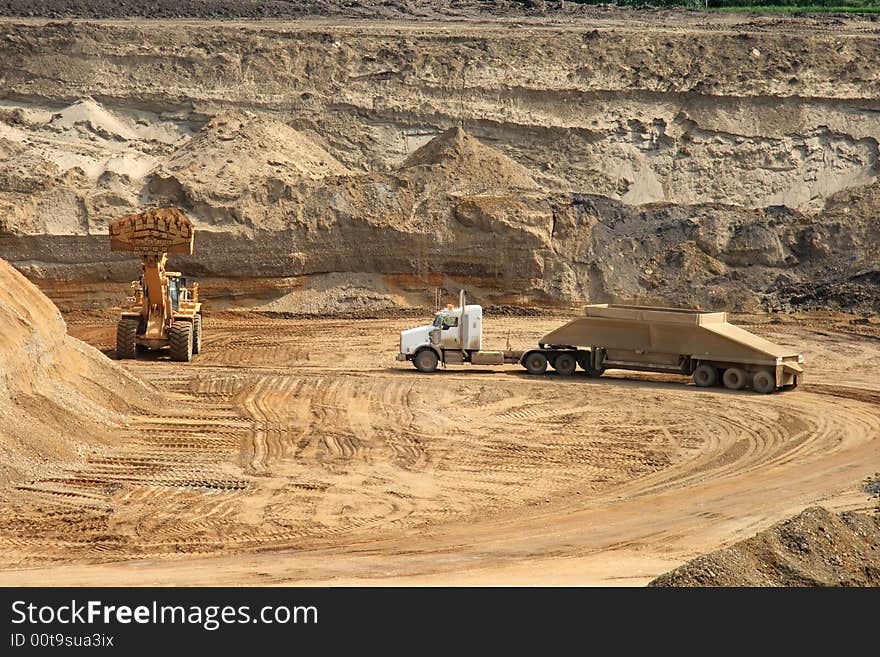 A gravel truck preparing to load in an open gravel pit. A gravel truck preparing to load in an open gravel pit