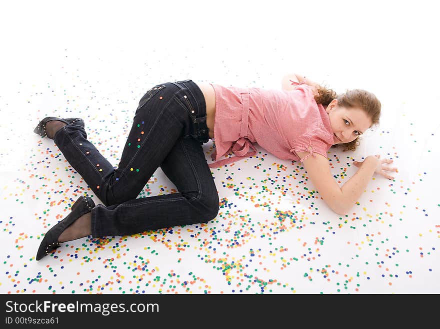 The young beautiful girl with the confetti isolated on a white background. The young beautiful girl with the confetti isolated on a white background