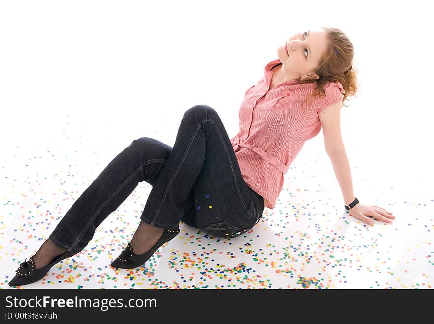 The young beautiful girl with the confetti isolated on a white background. The young beautiful girl with the confetti isolated on a white background