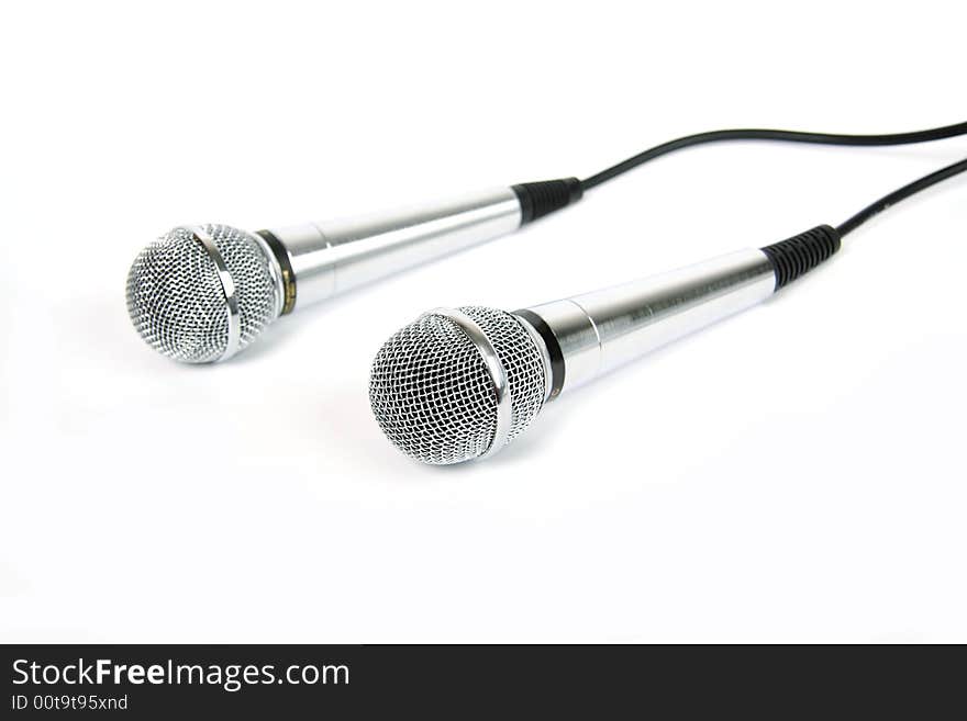 Two microphones with a black cord. Two microphones with a black cord.