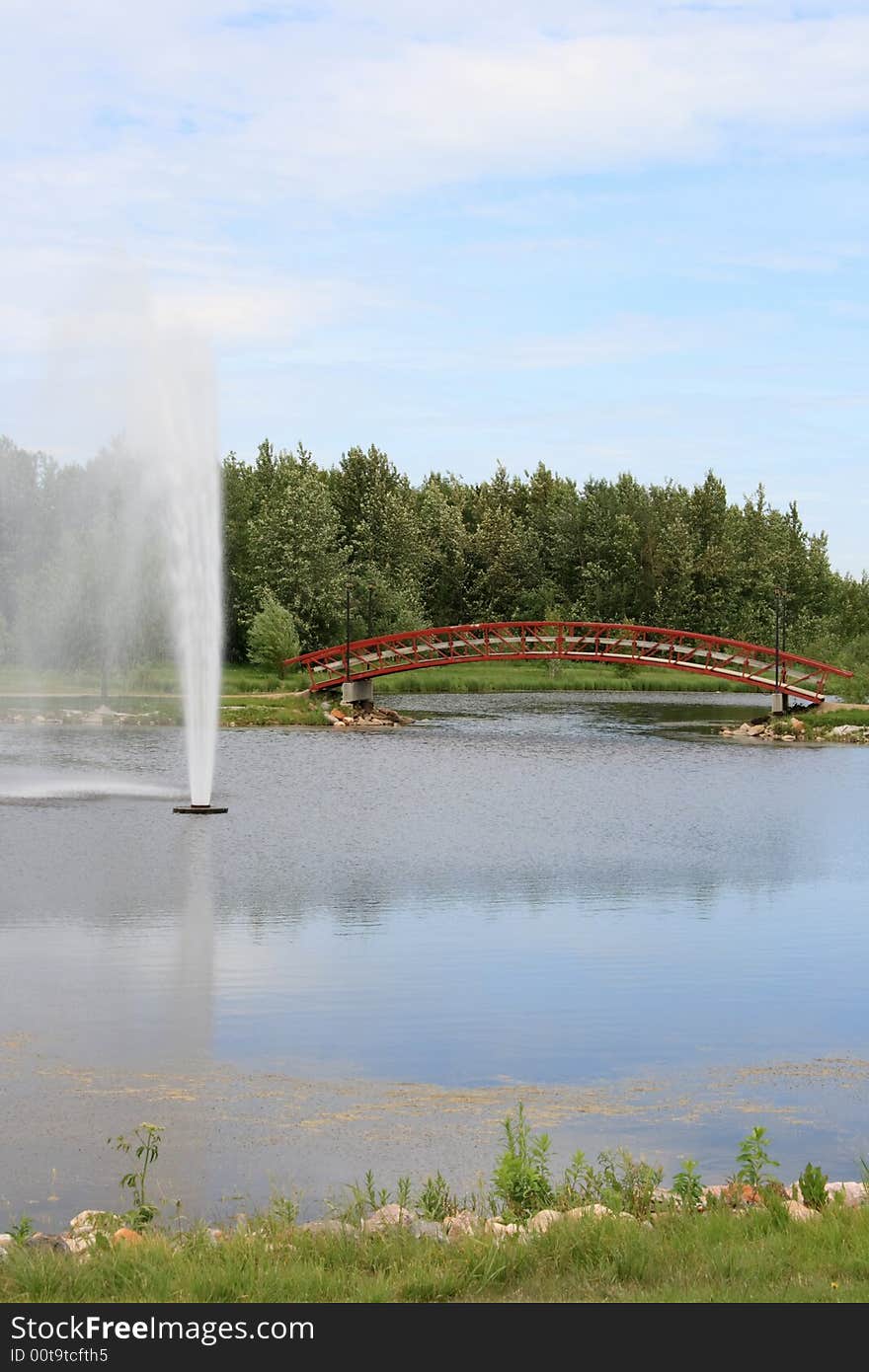 A large water fountain in a relaxing urban park setting. A large water fountain in a relaxing urban park setting