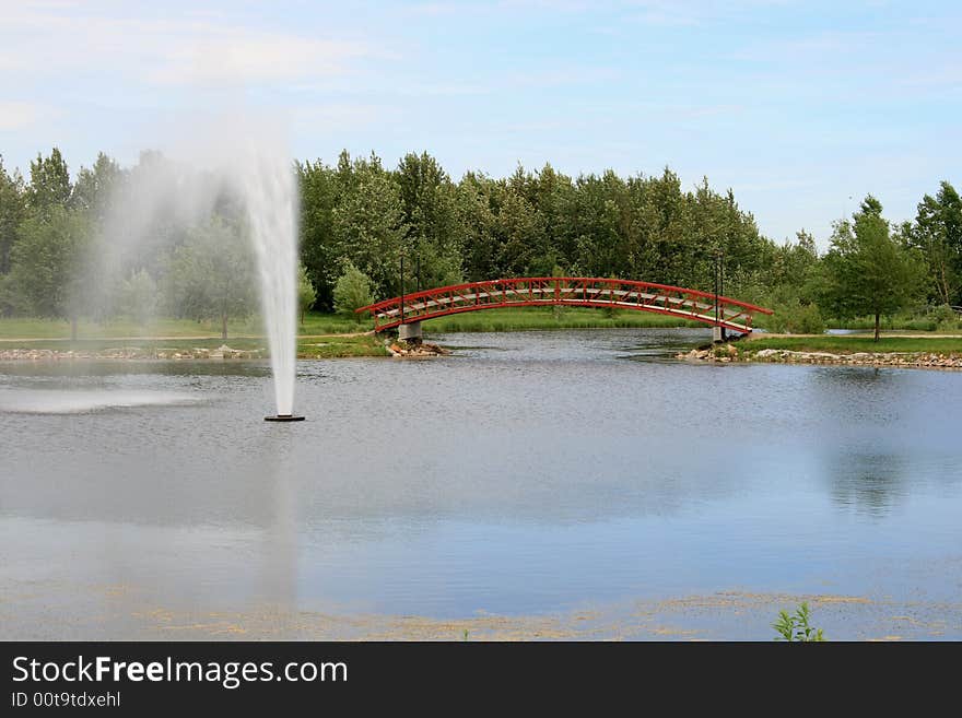 A large water fountain in a relaxing urban park setting. A large water fountain in a relaxing urban park setting