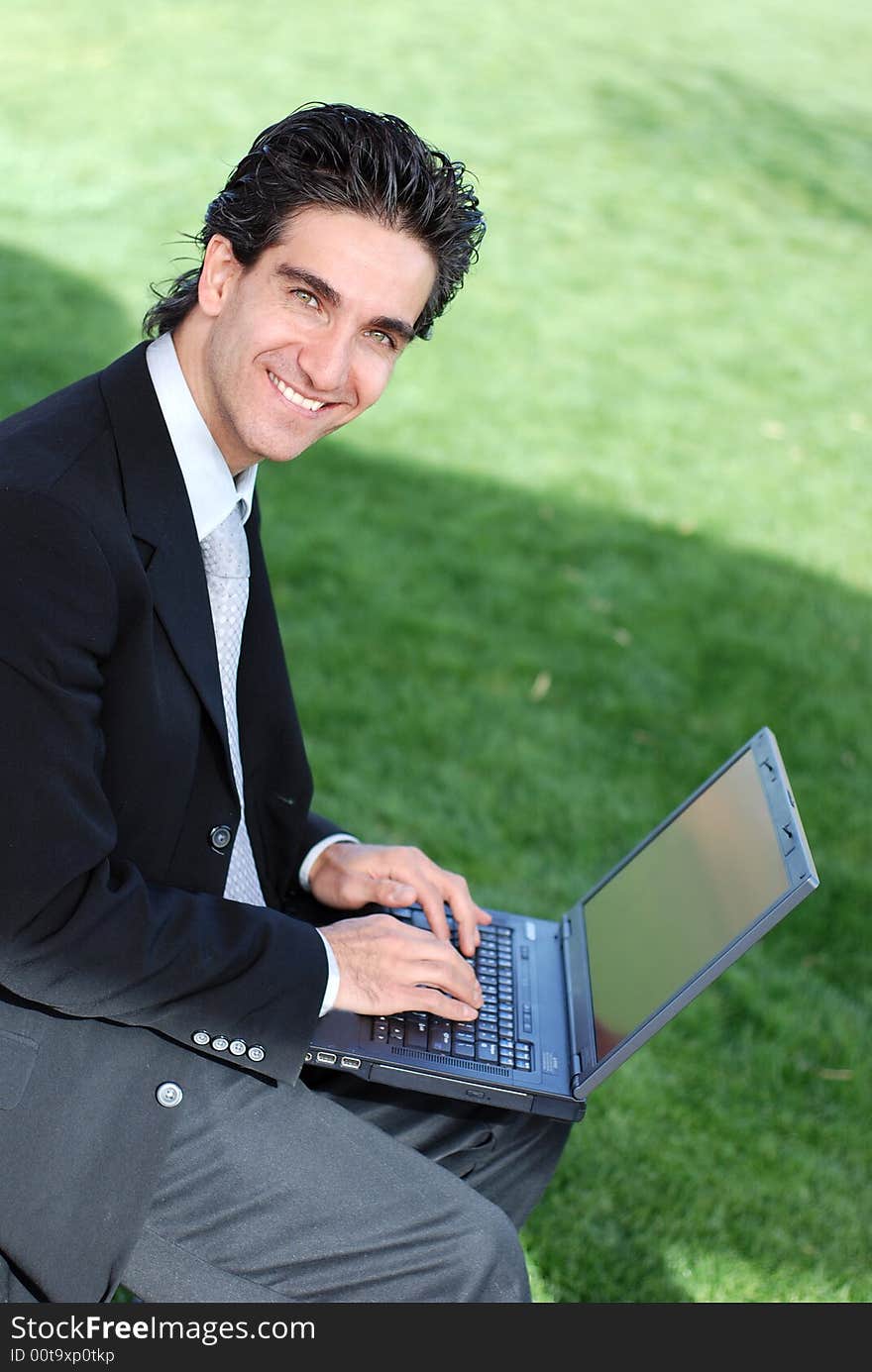 Happy businessman looking at his laptop