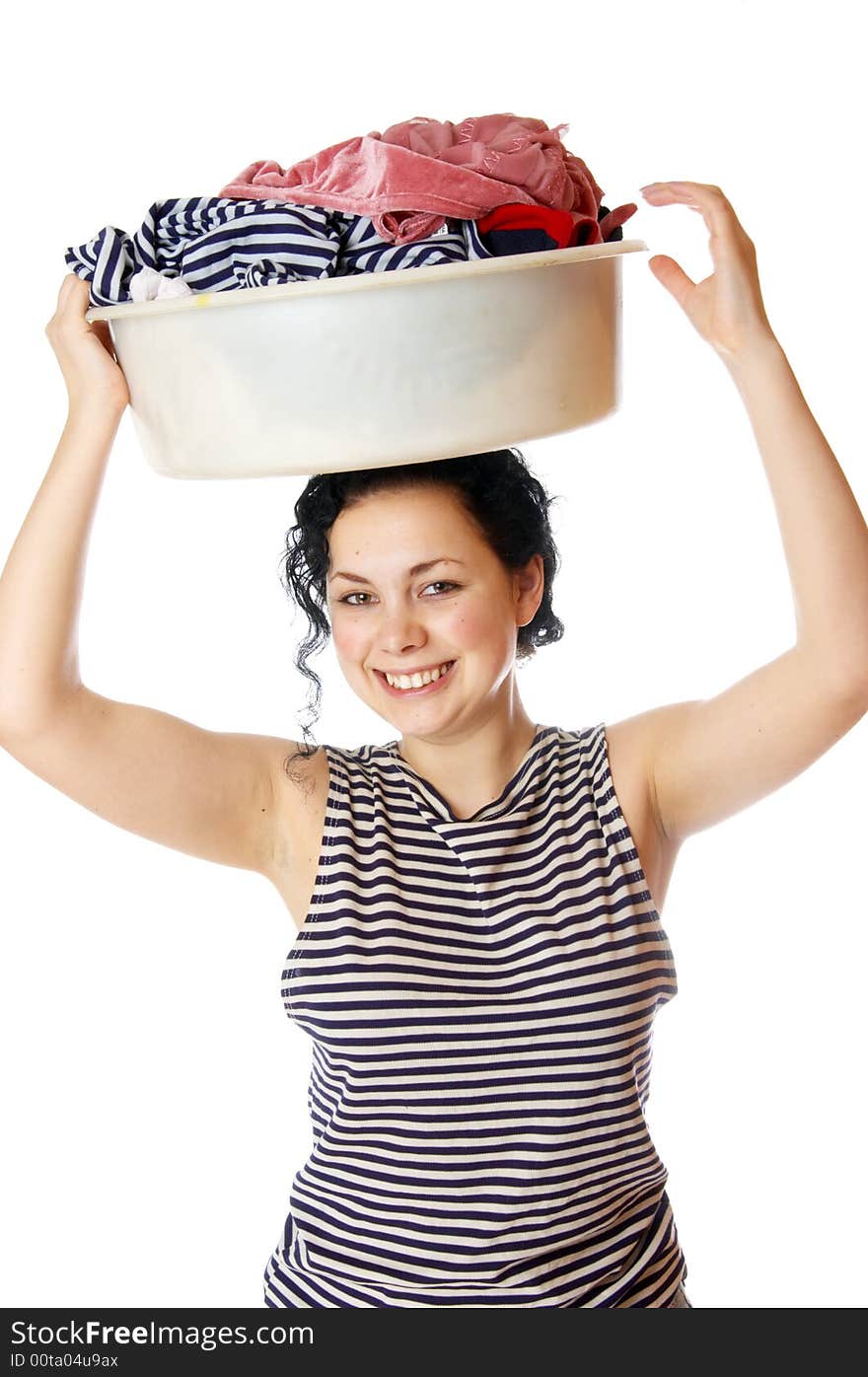 The beautiful girl holds a basin with clothes