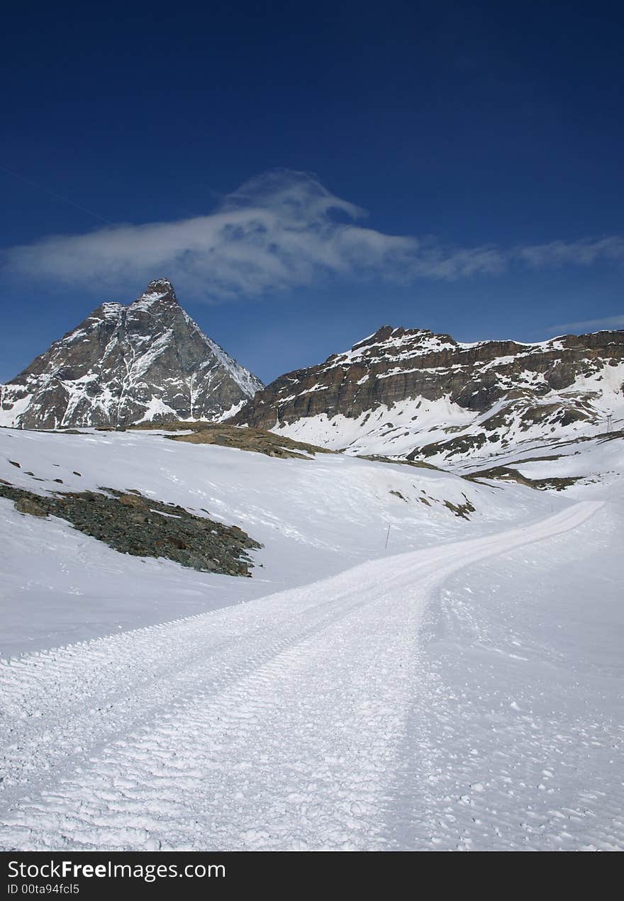 Mountain peak Matterhorn, road heading there, sight from Italy