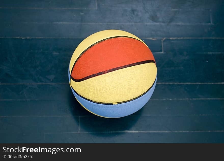 Very colorful basketball ball on wood floor