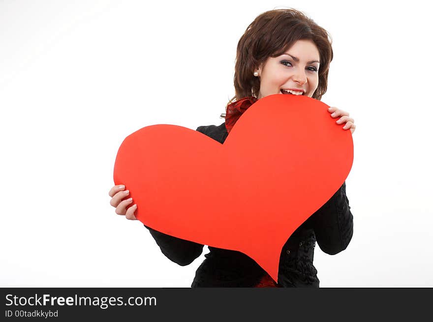 A woman biting a big red paper heart. A woman biting a big red paper heart