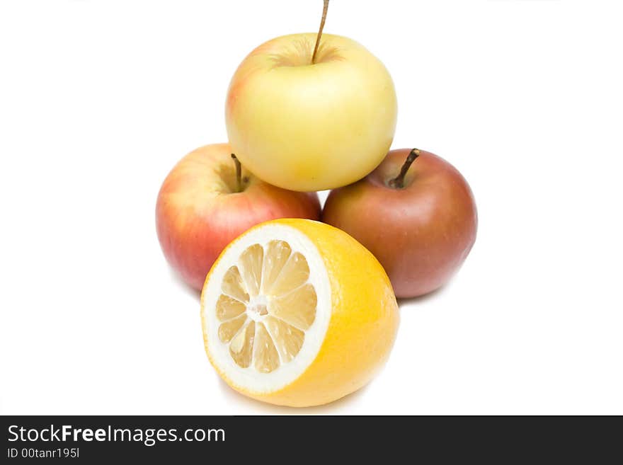 Three apples and lemon on the whie isolated background