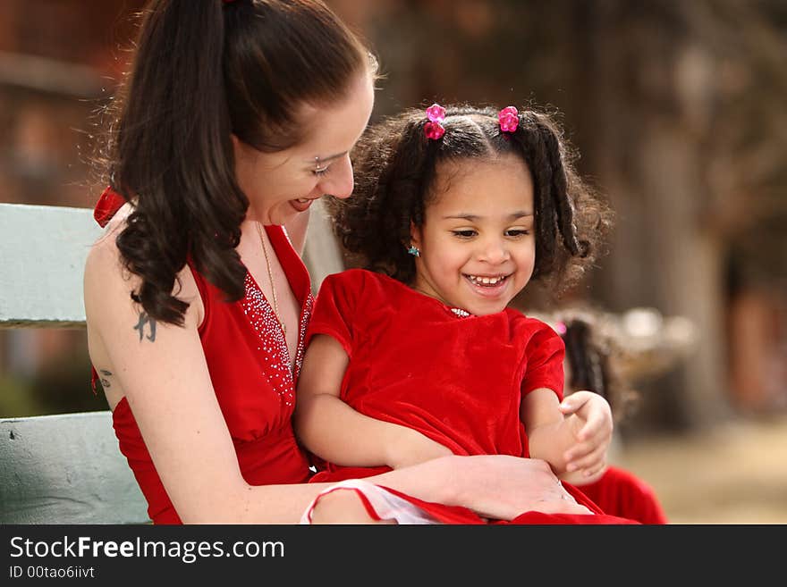 Beautiful multiracial childwith afro hairstyle playing with mother. Beautiful multiracial childwith afro hairstyle playing with mother